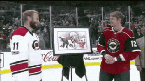 Hockey Player Number 12 Holding Framed Picture GIF