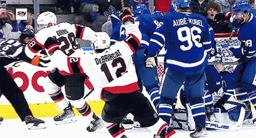 Hockey Player Number 12 Surrounded by Players