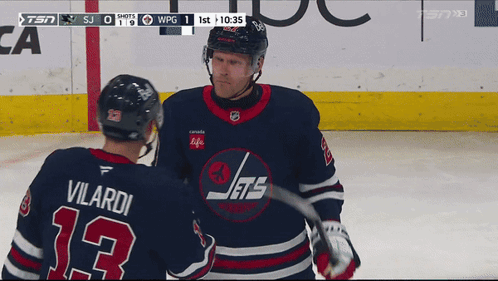 Hockey Player Number 13 Talking to Another Player