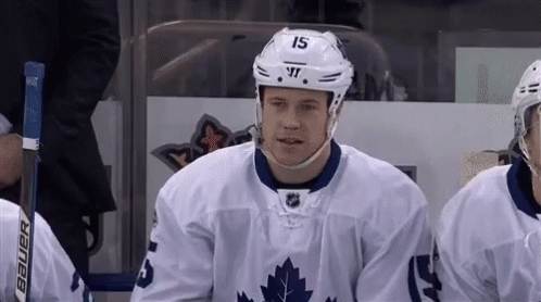 Hockey Player Number 15 Sitting on Bench