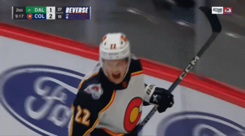 Hockey Player Number 22 Holding Stick