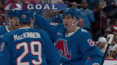 Hockey Player Number 29 Surrounded by Teammates