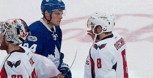 Hockey Player Number 8 Talks to Another Player