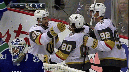 Hockey Player Number 80 Hugged by Two Players