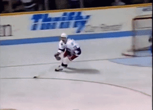 Hockey Player on Ice in Front of Thrifty Sign