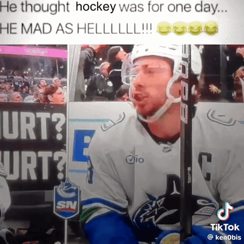 Hockey Player Sitting by Urt Sign