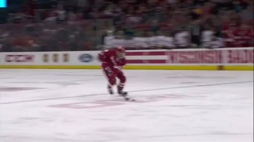 Hockey Player Skating in Front of CCM Banner