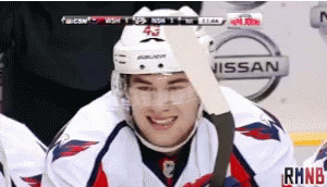 Hockey Player Smiling Near Nissan Advertisement GIF
