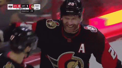 Hockey Player Smiling With A On Jersey