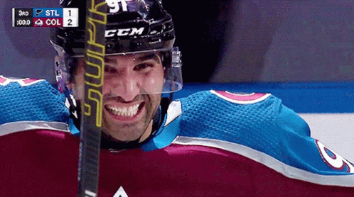Hockey Player Smiling with Stick
