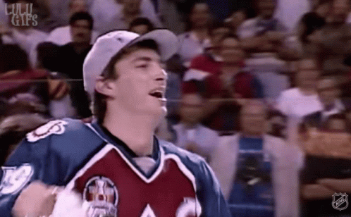 Hockey Player Standing in Front of Crowd