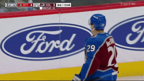 Hockey Player Standing in Front of Ford Logo
