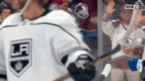 Hockey Player Waving in White Jersey