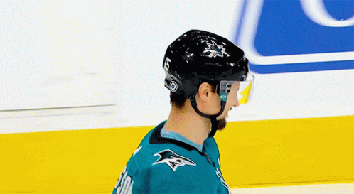 Hockey Player With Helmet and Sharks Jersey