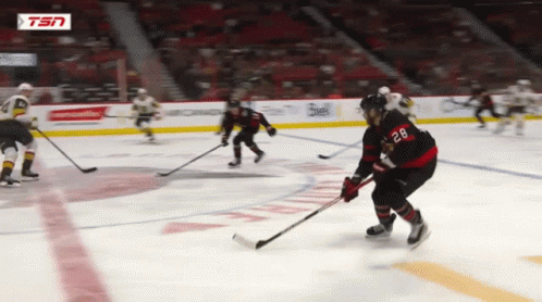 Hockey Player With Number 28 Holding Puck