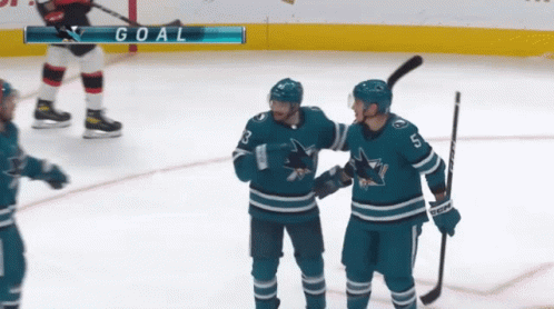 Hockey Players Celebrating Goal with Goal Scoreboard