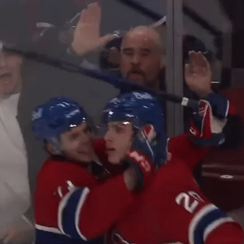 Hockey Players Celebrating Goal with Puck