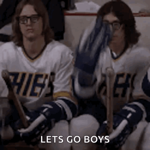 Hockey Players on Bench One Covering Face