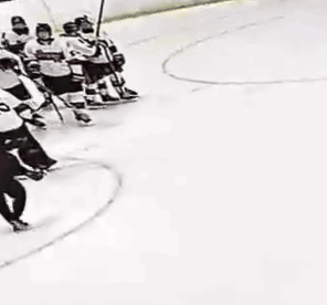 Hockey Players on Ice, One With Number 20