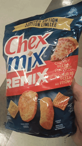 Holding Chex Mix Remix Pizza Crackers