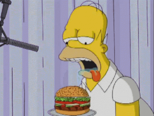 Homer Simpson Eating Hamburger In Front Of Microphone GIF