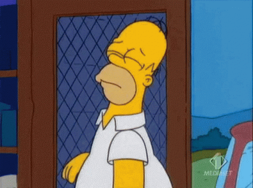 Homer Simpson From The Simpsons Is Standing In Front Of A Fence With His Eyes Closed .. GIF