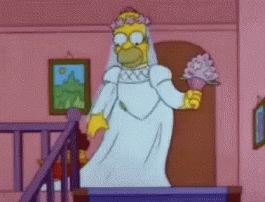 Homer Simpson Is Dressed As A Bride And Is Holding A Bouquet Of Flowers . GIF