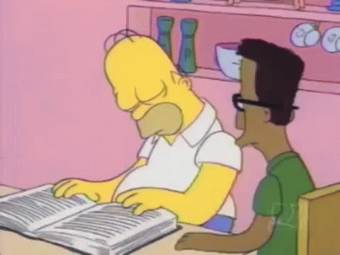 Homer Simpson Is Reading A Book While Sitting At A Table With A Man . GIF