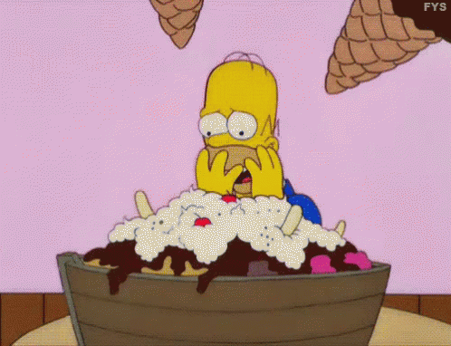 Homer Simpson Is Sitting In A Bucket Of Ice Cream With Ice Cream Cones Flying Around Him . GIF