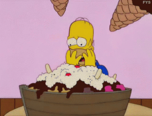 Homer Simpson Is Sitting In A Bucket Of Ice Cream With Ice Cream Cones Flying Around Him . GIF