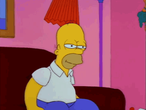 Homer Simpson Sitting On Couch In Pink Room GIF