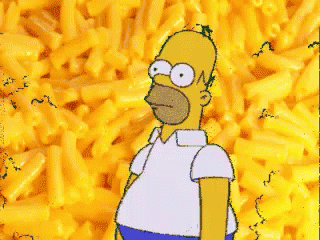 Homer Simpson Is Standing In Front Of A Pile Of Macaroni Cheese GIF