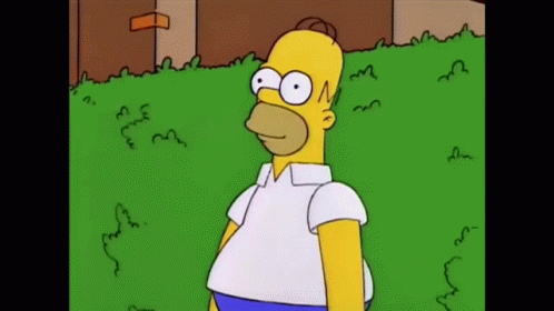 Homer Simpson Is Standing In The Grass Wearing A White Shirt GIF