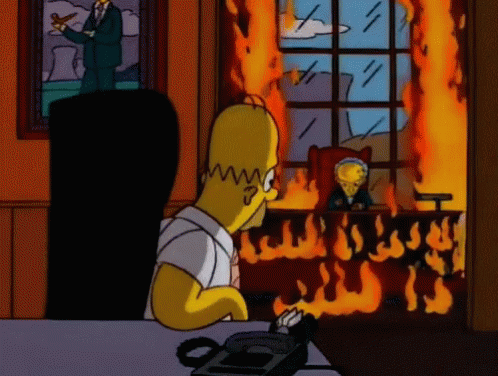 Homer Simpson Sits In Front Of A Burning Building GIF