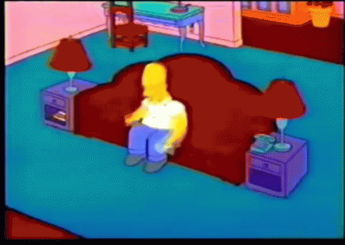 Homer Simpson Sits On A Red Couch In A Living Room GIF