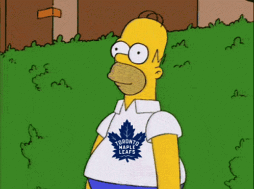 Homer Simpson Wearing A Toronto Raptors Shirt Stands In The Grass GIF