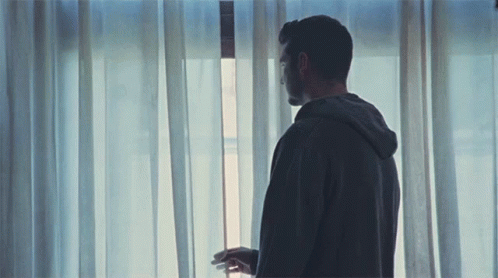 Hoodie Man Looking Out The Window GIF