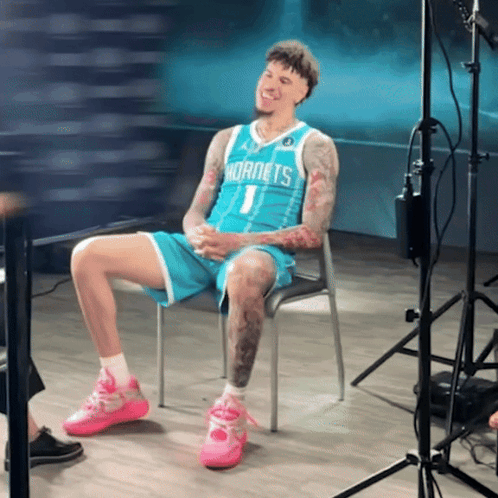Hornets Player Sitting With Legs Crossed GIF