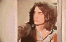 Man In Curly Hair Shakily Horrified GIF