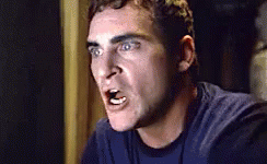 Horrified Joaquin Phoenix Hide In Cabinet GIF