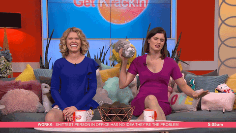 Host Giving Flowers To Audience GIF