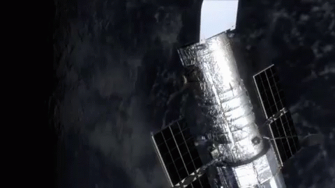 Hubble Space Telescope Flying Through Space