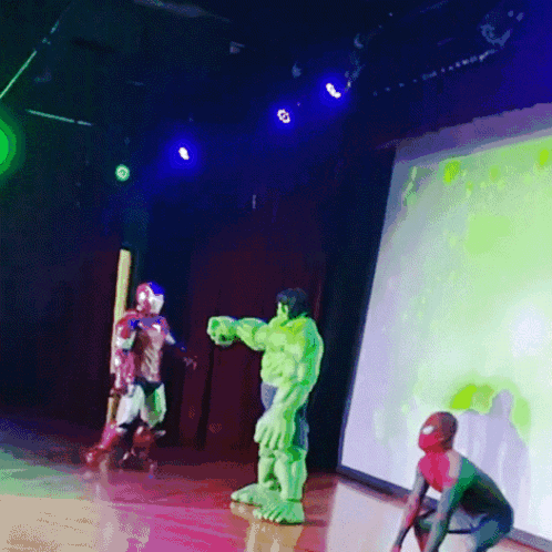 Hulk And Spider-Man Are On A Stage In Front Of A Screen GIF