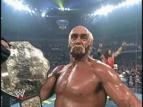 Hulk Hogan Is Holding A World Heavyweight Wrestling Championship Belt In A Ring . GIF