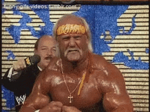 Hulk Hogan Is Wearing A Headband And Necklace With A Cross On It GIF