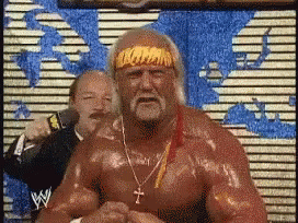 Hulk Hogan Is Wearing A Headband And Necklace With A Cross On It GIF