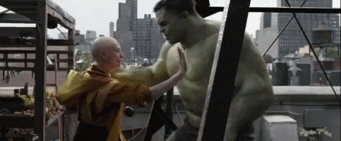 Hulk Is Giving A High Five To A Bald Woman On A Rooftop . GIF