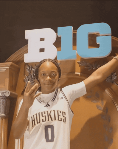 Huskies Player in Front of Big Sign