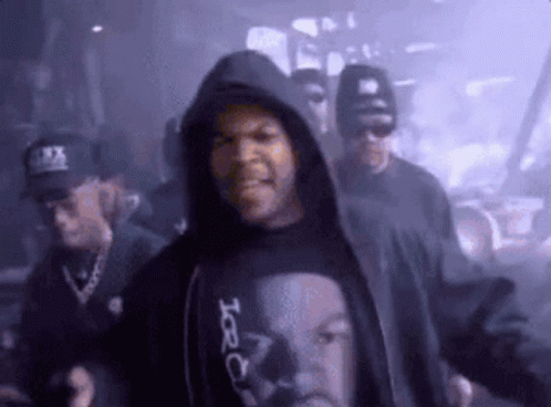 Ice Cube Is Wearing A Black Shirt With A Picture Of His Face On It . GIF