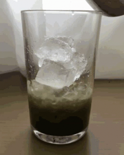 Ice Cubes Pouring Into Green Drink GIF